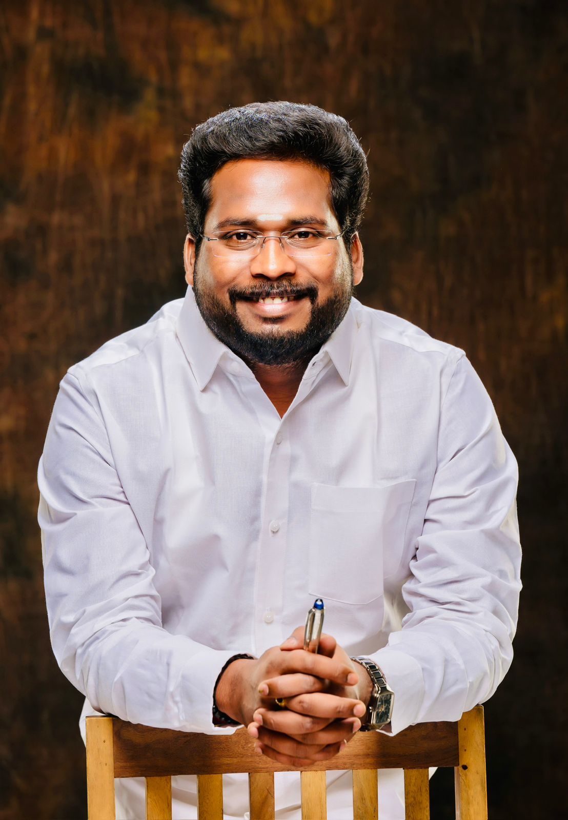 Tiruchi Suriyaa - Professional headshot in office